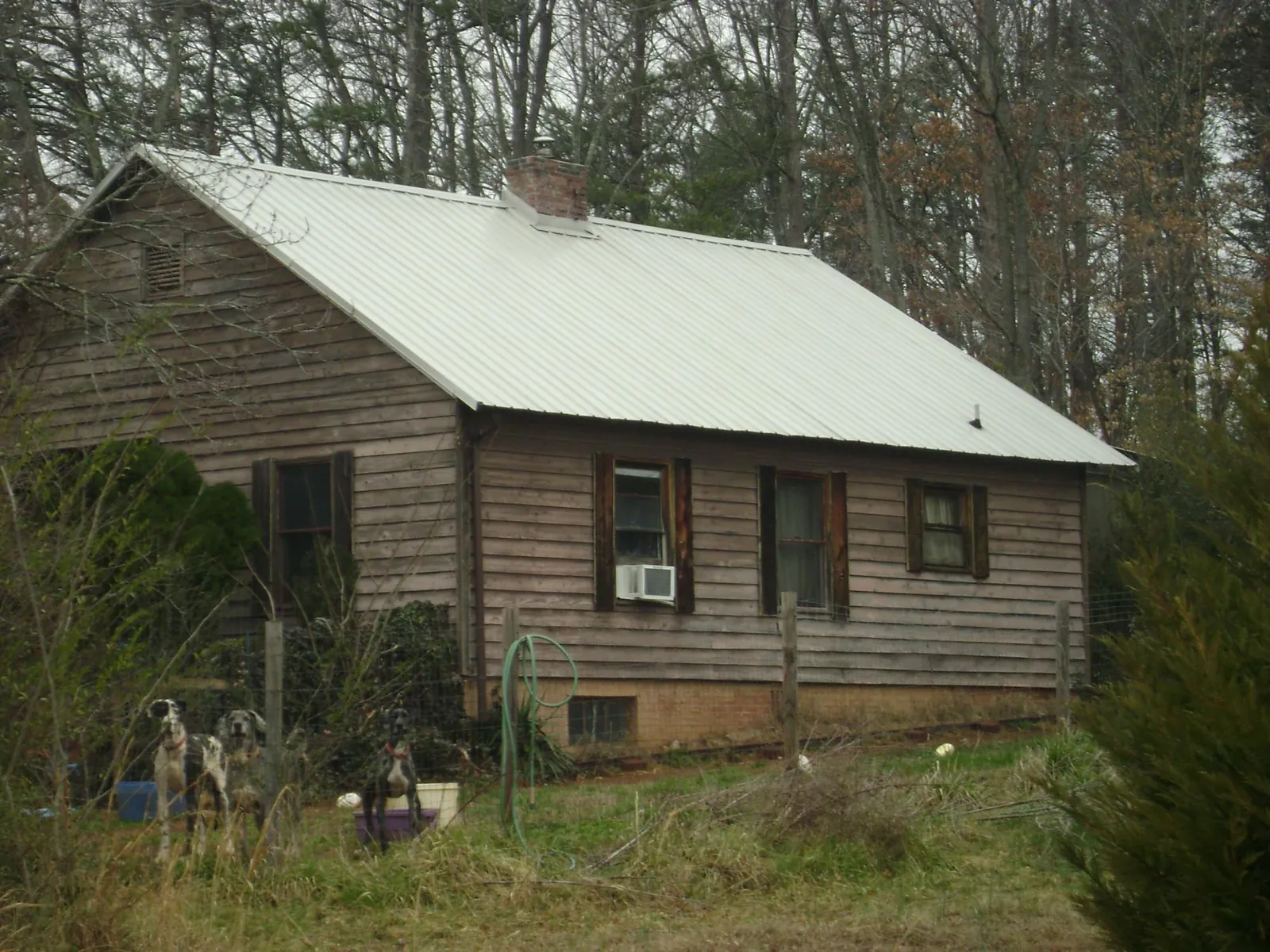 White metal roof on an old wood sided farmhouse, from a Metal Roof Installation job in New Windsor
